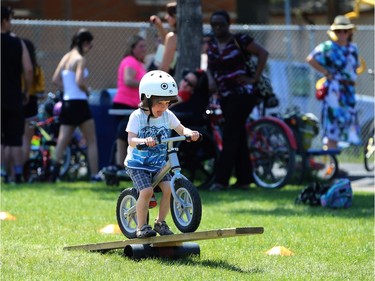 A youngster is cautious on an obstacle at Mulvey School during the Fam Jam Wheel Jam in Winnipeg on Sun., June 10, 2018. Kevin King/Winnipeg Sun/Postmedia Network
