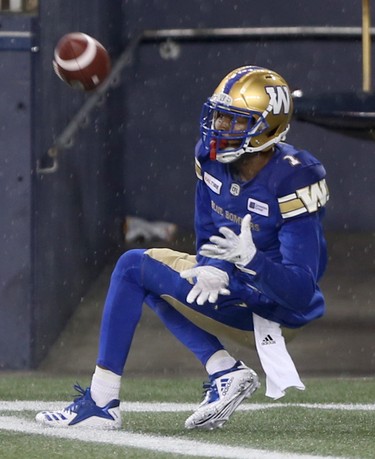 Winnipeg Blue Bombers' Darvin Adams (1) catches a touchdown pass during CFL action against the Edmonton Eskimos' in Winnipeg today.   Thursday, June 14, 2018.   Sun/Postmedia Network