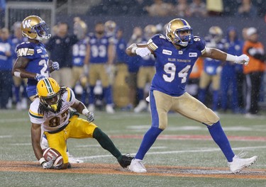 Winnipeg Blue Bombers' Jackson Jeffcoat (94) celebrates putting down Edmonton Eskimos' Derel Walker (87) during CFL action in Winnipeg today.   Thursday, June 14, 2018.   Sun/Postmedia Network