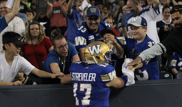 Winnipeg Blue Bombers QB Chris Streveler celebrates with fans in the end zone after throwing his first CFL touchdown pass, against the Edmonton Eskimos, during CFL action in Winnipeg on Thurs., June 14, 2018. Kevin King/Winnipeg Sun/Postmedia Network