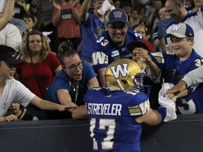 Winnipeg Blue Bombers QB Chris Streveler celebrates with fans in the end zone after throwing his first CFL touchdown pass, against the Edmonton Eskimos, during CFL action in Winnipeg on Thurs., June 14, 2018. Kevin King/Winnipeg Sun/Postmedia Network
