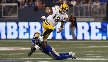 Winnipeg Blue Bombers DB Kevin Fogg stops Edmonton Eskimos QB Mike Reilly after a run during CFL action in Winnipeg on Thurs., June 14, 2018. Kevin King/Winnipeg Sun/Postmedia Network