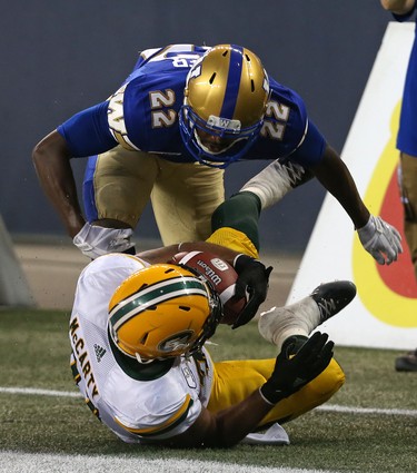 Winnipeg Blue Bombers DB Chandler Fenner (top) has words for Edmonton Eskimos FB Calvin McCarty after a tackle during CFL action in Winnipeg on Thurs., June 14, 2018. Kevin King/Winnipeg Sun/Postmedia Network