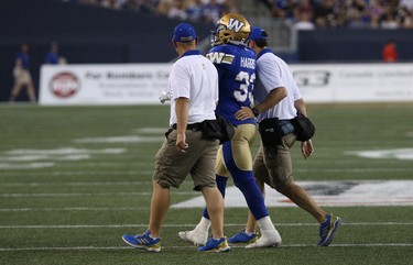 Winnipeg Blue Bombers RB Andrew Harris is helped off the field during CFL action against the Edmonton Eskimos in Winnipeg on Thurs., June 14, 2018. Kevin King/Winnipeg Sun/Postmedia Network