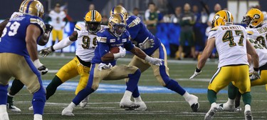 Winnipeg Blue Bombers RB Andrew Harris finds a hole in the Edmonton Eskimos defence during CFL action in Winnipeg on Thurs., June 14, 2018. Kevin King/Winnipeg Sun/Postmedia Network