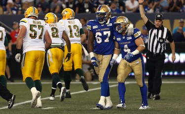 Winnipeg Blue Bombers DT Cory Johnson (left) celebrates a second-down stop against the Edmonton Eskimos during CFL action in Winnipeg with LB Adam Bighill on Thurs., June 14, 2018. Kevin King/Winnipeg Sun/Postmedia Network