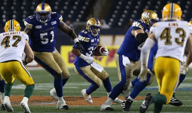 Winnipeg Blue Bombers RB Andrew Harris eyes a hole in the Edmonton Eskimos defence during CFL action in Winnipeg on Thurs., June 14, 2018. Kevin King/Winnipeg Sun/Postmedia Network