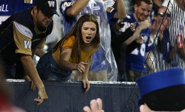 A fan tries to get the attention of a mascot during CFL action between the Winnipeg Blue Bombers and Edmonton Eskimos in Winnipeg on Thurs., June 14, 2018. Kevin King/Winnipeg Sun/Postmedia Network
