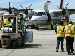 A forklift carries a refrigeration unit to a waiting aircraft at Winnipeg International Airport on Sun., June 17, 2018. The Canadian Red Cross is flying nearly 800 fridges and freezers to Pauingassi and Little Grand Rapids First Nations to replace units that had to be removed after residents were forced out of their homes by wildfires. Kevin King/Winnipeg Sun/Postmedia Network