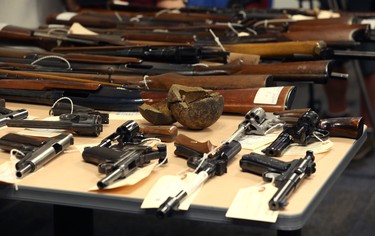 Some of the weapons turned in so far during the 2018 Manitoba Gun Amnesty initiative, including a 9-pound cannonball recovered by a citizen visiting York Factory in 1966, are displayed at Winnipeg police headquarters on Smith Street on Thurs., June 21, 2018. Kevin King/Winnipeg Sun/Postmedia Network