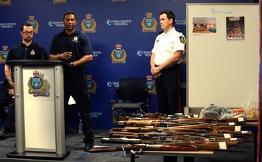 Csts. Marc Roemer (left) and Trevor Ogwal (centre) of the Firearms Investigative Analysis Section, along with Insp. Eric Luke, speak to some of the weapons turned in so far during the 2018 Manitoba Gun Amnesty initiative at Winnipeg police headquarters on Smith Street on Thurs., June 21, 2018. Kevin King/Winnipeg Sun/Postmedia Network