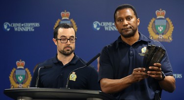 Cst. Trevor Ogwal (right) of the Firearms Investigative Analysis Section, with Cst. Marc Roemer, displays some illegal magazines turned in during the 2018 Manitoba Gun Amnesty initiative at Winnipeg police headquarters on Smith Street on Thurs., June 21, 2018. Kevin King/Winnipeg Sun/Postmedia Network