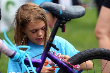 Sadie Van Winkle, 9, decorates her bike after completing the Ride Don't Hide event in support of mental health at Vimy Ridge Park in Winnipeg on Sun., June 24, 2018. Kevin King/Winnipeg Sun/Postmedia Network