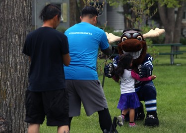 Winnipeg Jets mascot Mick E. Moose makes a friend at the Ride Don't Hide event in support of mental health at Vimy Ridge Park in Winnipeg on Sun., June 24, 2018. Kevin King/Winnipeg Sun/Postmedia Network