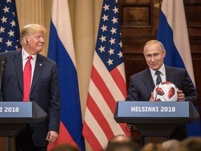 Russian President Vladimir Putin hands U.S. President Donald Trump (L) a World Cup football during a joint press conference after their summit on July 16, 2018 in Helsinki, Finland. Putin has every reason to be pleased with their meeting.