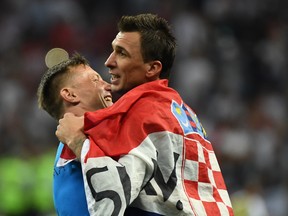 Croatia's Mario Mandzukic (right) celebrates with assistant coach Ivica Olic after beating England on Wednesday. (GETTY IMAGES)