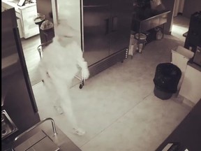 In a video posted to Facebook, a man dressed all in white, a light-coloured cap and white sneakers can be seen rummaging through the store's kitchen, opening the fridge and drawers presumably looking for something to steal.