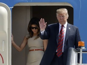 U.S. President Donald Trump and First Lady Melania Trump disembark from Air Force One as they arrive at London Stansted Airport in Stansted, England, Thursday, July 12, 2018.
