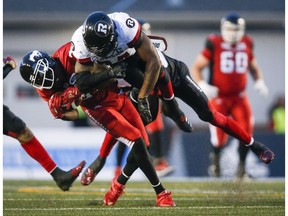 Ottawa Redblacks' Kyries Hebert, right, slams into Calgary Stampeders' DaVaris Daniels, during second half CFL football action in Calgary, Thursday, June 28. Photo by Jeff McIntosh/The Canadian Press.