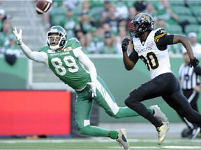 Saskatchewan's Duron Carter stretches for an attempted interception against Hamilton receiver Terrence Toliver.