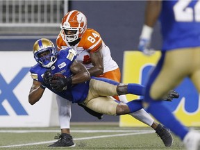 Winnipeg Blue Bombers' Chris Randle (8) intercepts the pass intended for BC Lions' Emmanuel Arceneaux (84) during the second half of CFL action in Winnipeg Saturday, July 7, 2018.