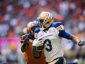 Winnipeg Blue Bombers' Kevin Fogg, front, runs the ball past B.C. Lions' Ricky Collins Jr. after making an interception in the end zone during the first half of a CFL football game in Vancouver on Saturday July 14, 2018. THE CANADIAN PRESS/Darryl Dyck ORG XMIT: VCRD112