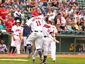 Goldeyes’ Reggie Abercrombie celebrates his three-run homer with Josh Mazzola. The hit set the Goldeyes on the path to a 13-0 victory over the Airhogs on Tuesday night.  Dan LeMoal/photo