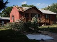 Debris lies on the ground as residents clean up after a tornado swept through Bondurant, Iowa, Thursday, July 19, 2018.