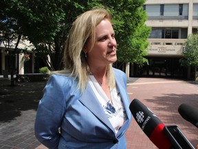 Mayoral hopeful Jenny Motkaluk speaks outside of City Hall on Wednesday, July 4, as she announces another election promise to put more police officers on city streets. Joyanne Pursaga/Postmedia