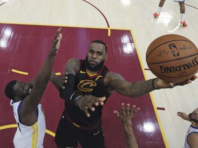 In this June 6, 2018, file photo, Cavaliers' LeBron James shoots against Warriors' Draymond Green during Game 3 of the NBA Finals, in Cleveland.