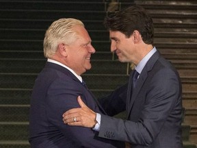 Ontario Premier Doug Ford greets Canadian Prime Minister Justin Trudeau at the Ontario Legislature, in Toronto on Thursday, July 5, 2018.