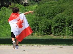 A young boy wrapped in a Canadian flag celebrates Canada Day.
Winnipeg Sun file