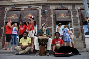 Ras Rico (center) plays Rasta Fari Caribbean music on the djembe drum at the TELUS Osborne Village Street Festival and Canada Day Celebration in Winnipeg on Sunday, July 1, 2018.