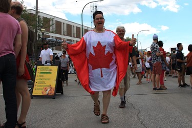 Sandy Cheadle celebrates Canada Day dressed in a Canadian flag at the TELUS Osborne Village Street Festival and Canada Day Celebration in Winnipeg on Sunday, July 1, 2018.