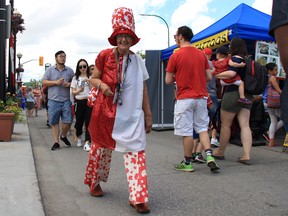 Kathy Taylor celebrates Canada Day dressed in a red and white at the TELUS Osborne Village Street Festival and Canada Day Celebration.