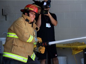 Isaiah Hunt, a camper from the Winnipeg Fire Paramedic Services (WFPS) career camp, shoots a fire hose during a firefighter and paramedic relay course during the final day of the week long camp at the WFPS Training Academy on Friday.