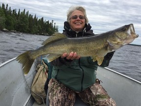 A happy angler show off a prize walleye.