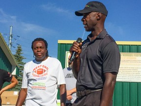 Former police Chief Devon Clunis (right) speaks at the sixth annual West End Futures Football Clinic for youth ages nine to 21 at the North Winnipeg Nomads Minor Football Club field hosted by mayoral candidate Don Woodstock (left) on Saturday.