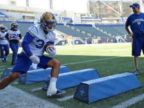 Andrew Harris takes part in a drill with running backs coach Kevin Bourgoin looking on during Winnipeg Blue Bombers practice on Wed., July 18, 2018. Kevin King/Winnipeg Sun/Postmedia Network