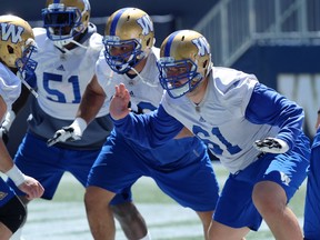 Matthias Goossen (right) and Sukh Chungh (centre) explode off the line during Winnipeg Blue Bombers practice on Wed., July 18, 2018. Kevin King/Winnipeg Sun/Postmedia Network