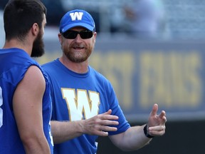 Head coach Mike O'Shea (right) speaks with Craig Roh during Winnipeg Blue Bombers practice on Wed., July 18, 2018. Kevin King/Winnipeg Sun/Postmedia Network