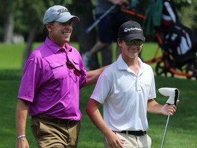 Todd Fanning (left) walks off the 18th green with son Nic, his caddie, after finishing third at the provincial men's amateur championship at Glendale Golf and Country Club in Winnipeg on Thurs., July 19, 2018. Kevin King/Winnipeg Sun/Postmedia Network