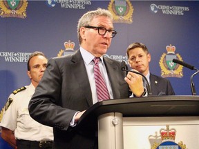 Winnipeg Police Board Chair David Asper is flanked by Mayor Brian Bowman (right) and Winnipeg police Chief Danny Smyth (left) at police headquarters following the release of the Winnipeg police's crime statistics for 2017.