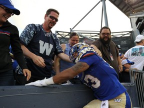 Winnipeg Blue Bombers RB Andrew Harris celebrates a touchdown catch from Nic Demski with the fans in the stands during CFL action against the Toronto Argonauts in Winnipeg on Fri., July 27, 2018. Kevin King/Winnipeg Sun/Postmedia Network