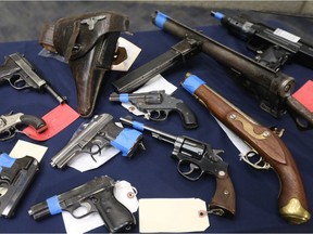 Firearms collected by police were displayed at a news conference in Winnipeg Tuesday. Police recently encouraged citizens to voluntarily surrender weapons and ammunition during a firearms amnesty.