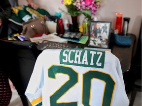 The family of Logan Schatz sets up a makeshift memorial of their son's photos and jersey at their home in Allan, Sask., in early April. The Canadian National Ball Hockey Championship in Winnipeg next week will be dedicated to the Humboldt Broncos captain and the rest of those killed in the bus crash involving the Saskatchewan junior hockey team in April.