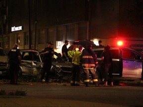 Emergency personnel attend to the scene of a three-car collision at the Disraeli Freeway at Main Street, which occurred shortly after 1:30 a.m., on Sunday.