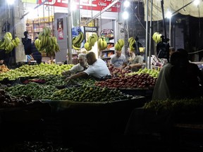 People buy provisions at a market in the mostly rebel-held northern Syrian Idlib province on the eve of Eid al-Adha on Monday. Muslims across the world are celebrating Eid al-Adha by visiting the tombs of their loved ones and slaughtering sheep, goats, cows and camels, marking the end of the Hajj pilgrimage to Mecca and in commemoration of Prophet Abraham's readiness to sacrifice his son Ismail on God's command. (ZEIN AL RIFAI/AFP/Getty Images)