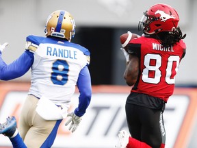 Calgary Stampeders Marken Michel with a touchdown catch in front of Chris Randle of the Winnipeg Blue Bombers during CFL football in Calgary on Saturday, August 25, 2018. Al Charest/Postmedia