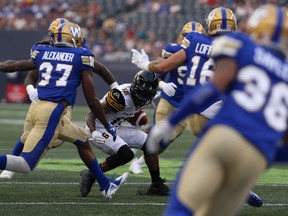Tiger-Cats WR Brandon Banks is surrounded by Bombers defenders last night in Winnipeg. (Kevin King/Winnipeg Sun)